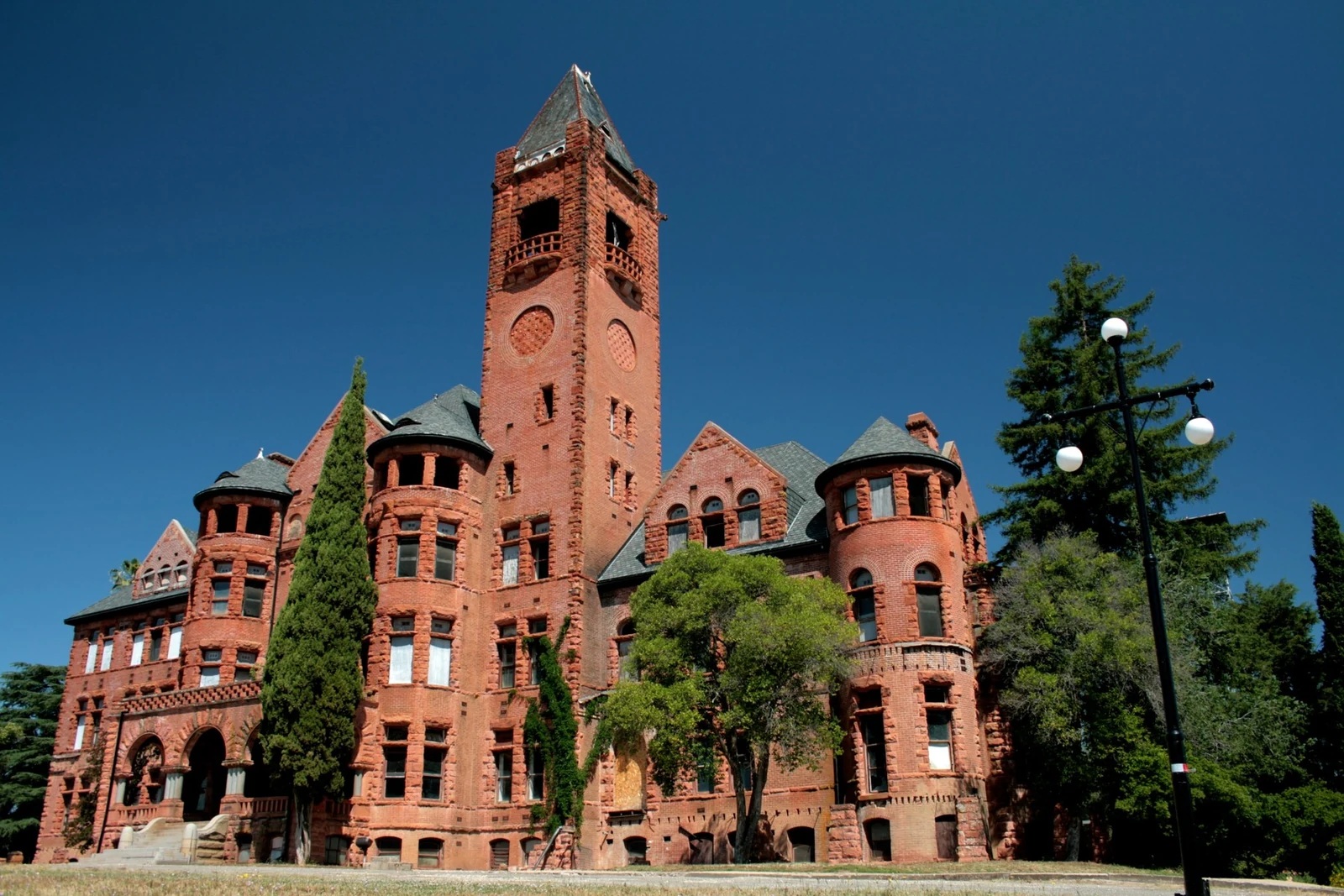 The red-brick towers and arches of Preston Castle in Ione beneath a clear blue sky